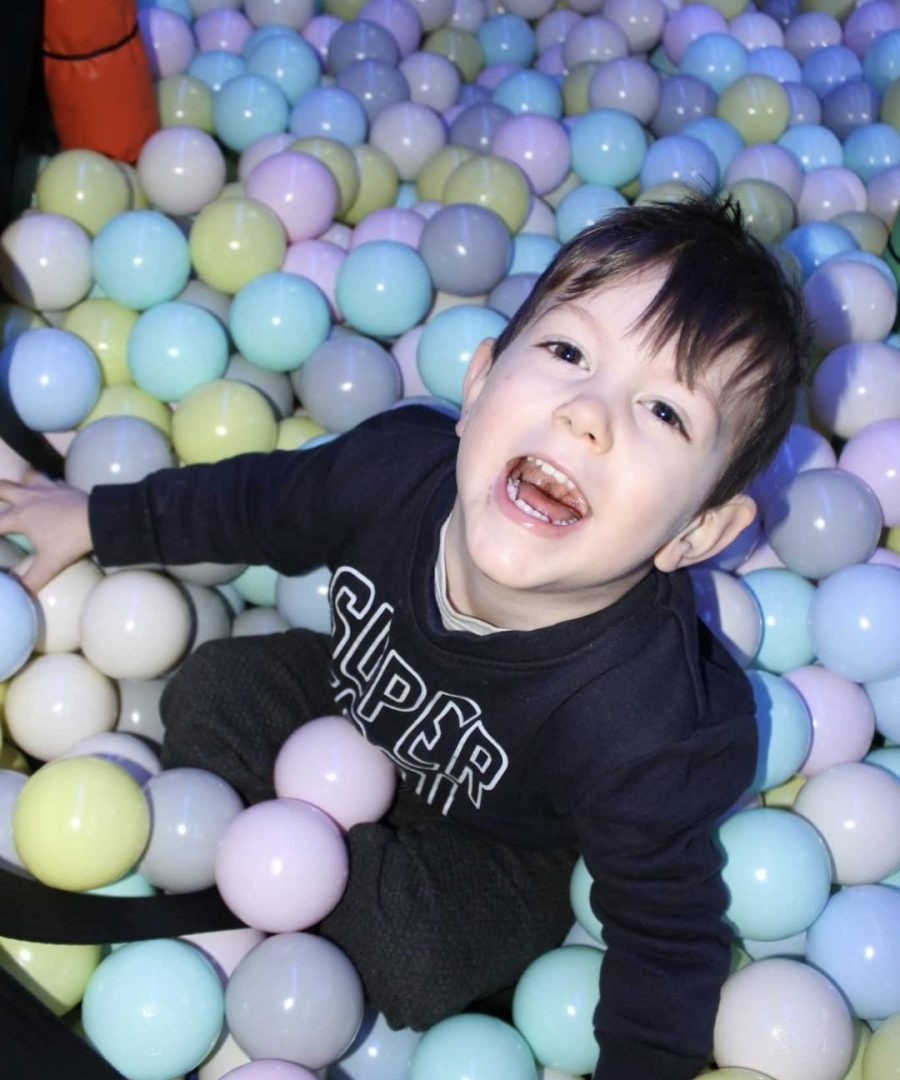 VoJo's Playbus - Happy child having fun in ball pit on mobile soft play bus in London